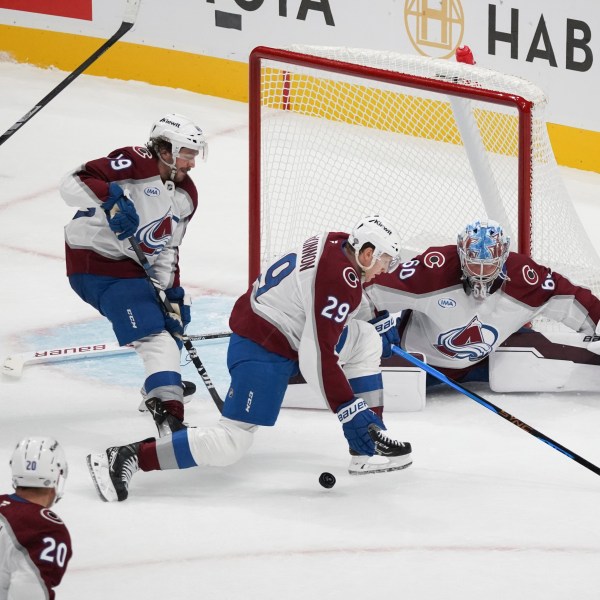 Colorado Avalanche players Samuel Girard (49), center left, Nathan MacKinnon (29), center right, and Justus Annunen (60), far right, defend a shot as San Jose Sharks left wing Fabian Zetterlund (20) looks to score during the third period of an NHL hockey game in San Jose, Calif., Sunday, Oct. 20, 2024. (AP Photo/Minh Connors)