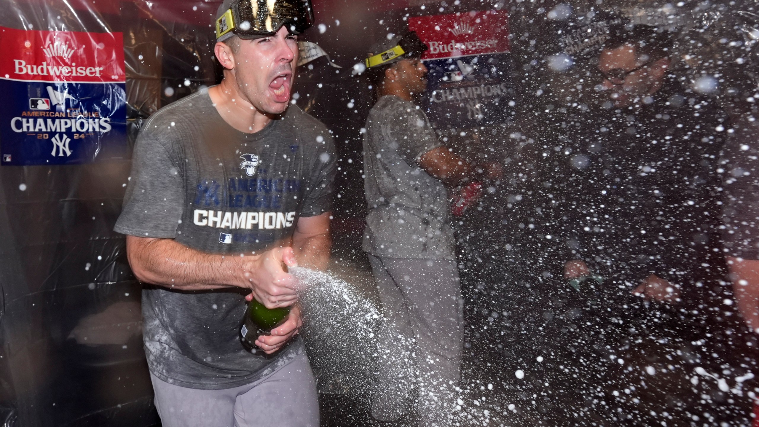 New York Yankees' Carlos Rodón celebrates in the clubhouse after Game 5 of the baseball AL Championship Series against the Cleveland Guardians Sunday, Oct. 20, 2024, in Cleveland. The Yankees won 5-2 to advance to the World Series. (AP Photo/Godofredo A. Vásquez )