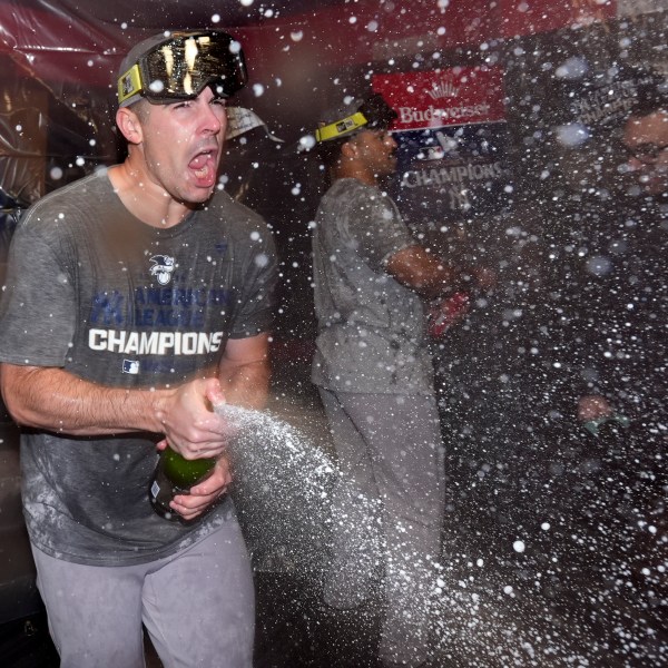 New York Yankees' Carlos Rodón celebrates in the clubhouse after Game 5 of the baseball AL Championship Series against the Cleveland Guardians Sunday, Oct. 20, 2024, in Cleveland. The Yankees won 5-2 to advance to the World Series. (AP Photo/Godofredo A. Vásquez )