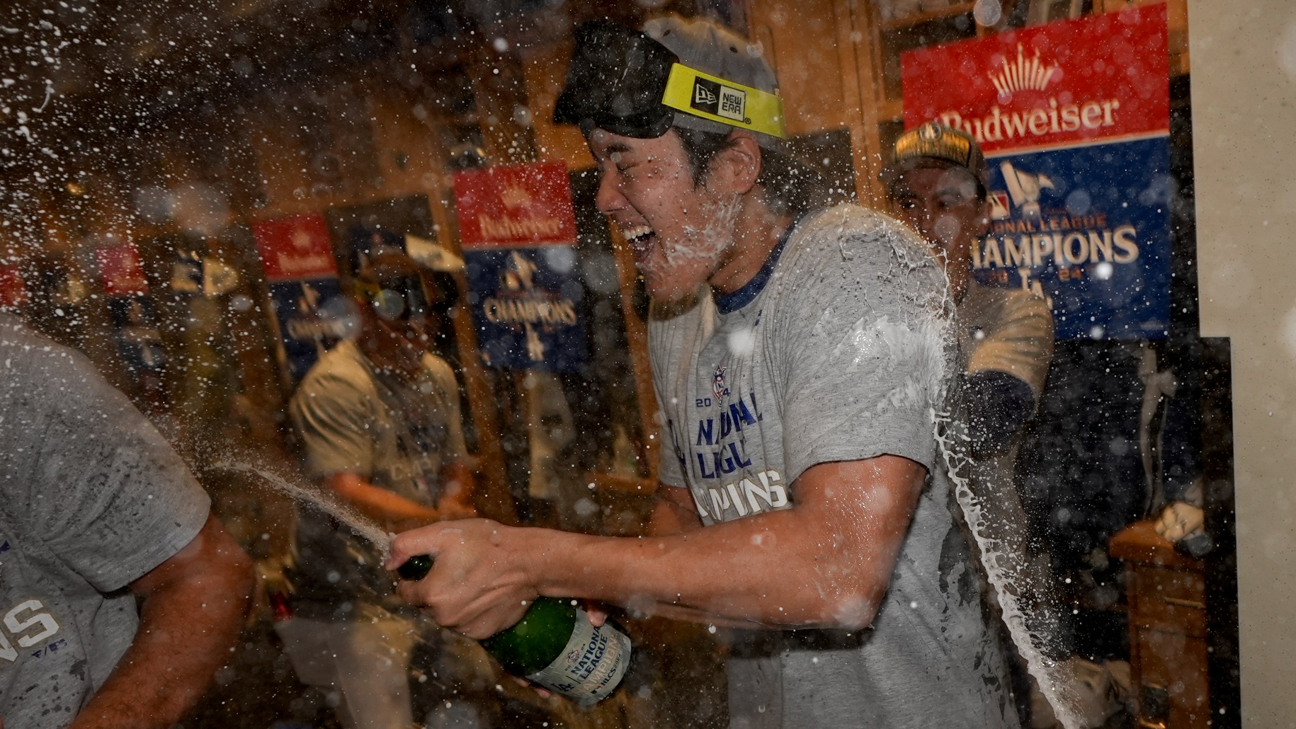 Los Angeles Dodgers Shohei Ohtani celebrates in the locker room after their win against the New York Mets in Game 6 of a baseball NL Championship Series, Sunday, Oct. 20, 2024, in Los Angeles. The Dodgers will face the New York Yankees in the World (AP Photo/Ashley Landis)