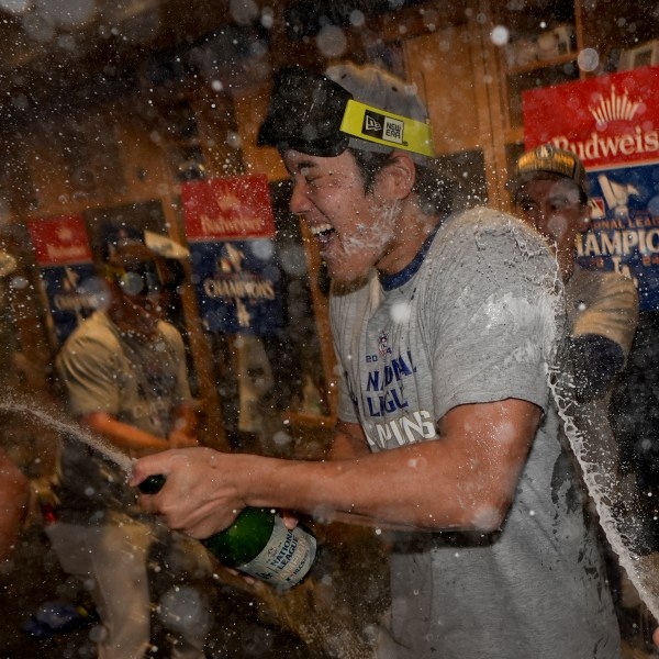 Los Angeles Dodgers Shohei Ohtani celebrates in the locker room after their win against the New York Mets in Game 6 of a baseball NL Championship Series, Sunday, Oct. 20, 2024, in Los Angeles. The Dodgers will face the New York Yankees in the World (AP Photo/Ashley Landis)