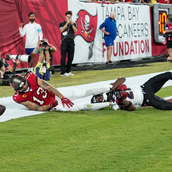 Baltimore Ravens cornerback Brandon Stephens (21) breaks up a pass intended for Tampa Bay Buccaneers wide receiver Mike Evans (13) during the first half of an NFL football game, Monday, Oct. 21, 2024, in Tampa, Fla. (AP Photo/Chris O'Meara)