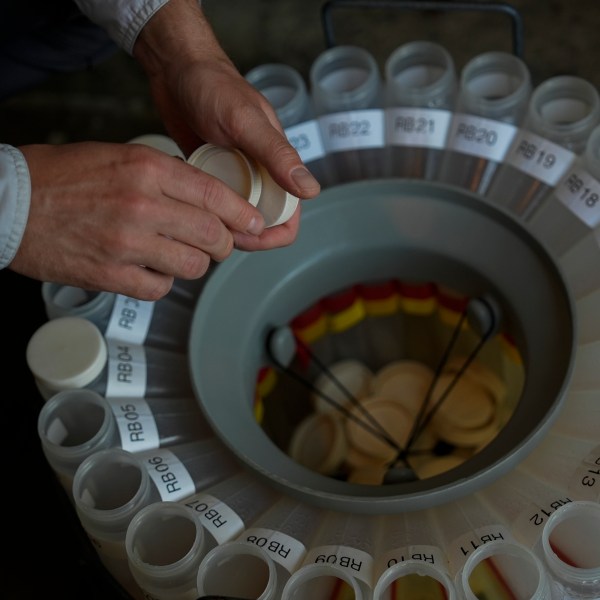 Jake Boehler, field manager at the National Center for Water Quality Research, collects water samples from a monitoring station, Monday, Aug. 26, 2024, in Woodville, Ohio. (AP Photo/Joshua A. Bickel)