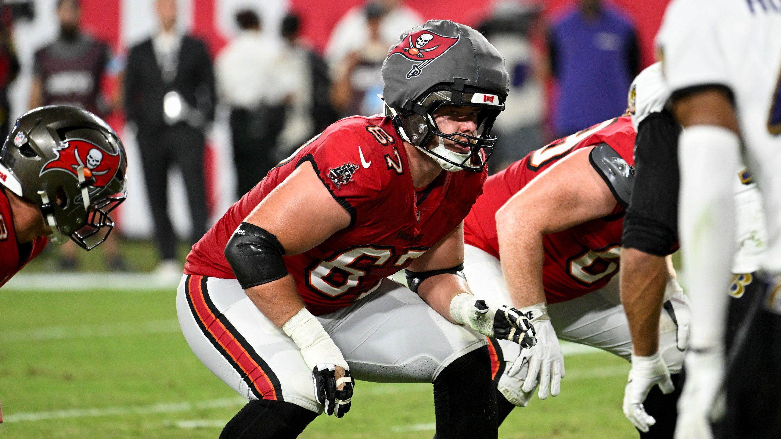 Tampa Bay Buccaneers offensive tackle Luke Goedeke (67) wears a protective cap during the first half of an NFL football game against Baltimore Ravens, Monday, Oct. 21, 2024, in Tampa, Fla. (AP Photo/Jason Behnken)