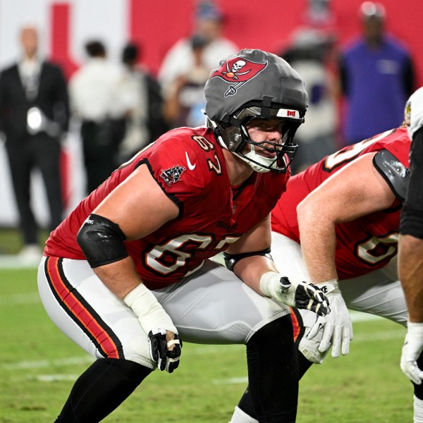 Tampa Bay Buccaneers offensive tackle Luke Goedeke (67) wears a protective cap during the first half of an NFL football game against Baltimore Ravens, Monday, Oct. 21, 2024, in Tampa, Fla. (AP Photo/Jason Behnken)