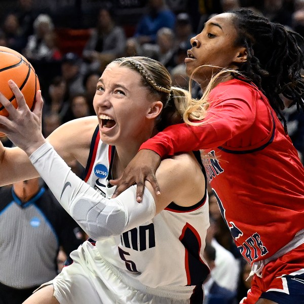 FILE - UConn guard Paige Bueckers, left, is fouled by Jackson State guard Miya Crump in the first half of a first-round college basketball game in the NCAA Tournament, Saturday, March 23, 2024, in Storrs, Conn. (AP Photo/Jessica Hill, File)