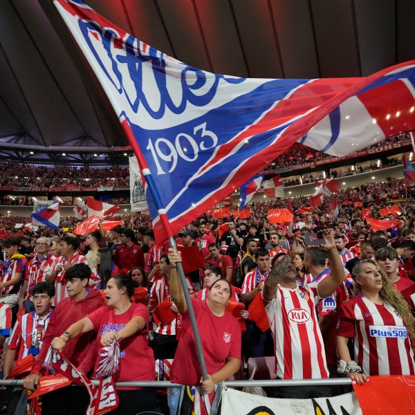 Atletico fans cheer before the La Liga soccer match between Atletico Madrid and Real Madrid at the Metropolitano stadium in Madrid, Spain, Sunday, Sept. 29, 2024. (AP Photo/Bernat Armangue)