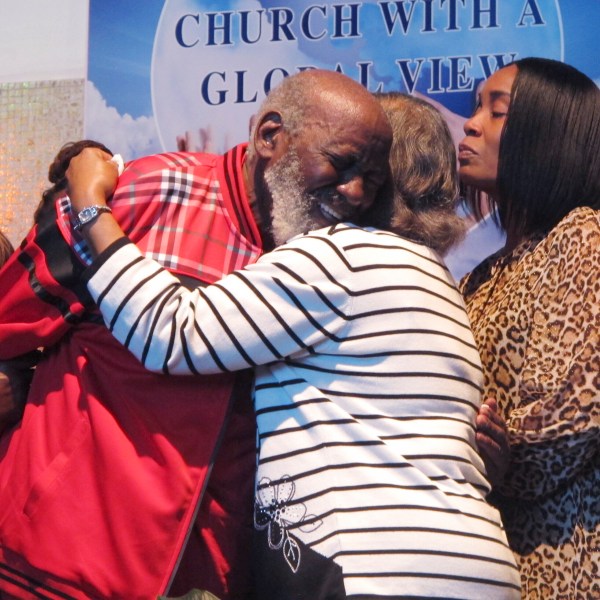 Wilbert Gardner, left, hugs Katrena Alexander while Alexander's daughter, Regina Brinson, right, looks on during a news conference Tuesday, Oct. 22, 2024, in Jacksonville, Fla, A dock gangway collapse happened as people were leaving a cultural festival on Sapelo Island, Georgia, on Saturday, Oct. 19, 2024. Alexander's brother, Isaiah Thomas, was among the dead. Gardner had a friend who was hospitalized with injuries. (AP Photo/Russ Bynum)