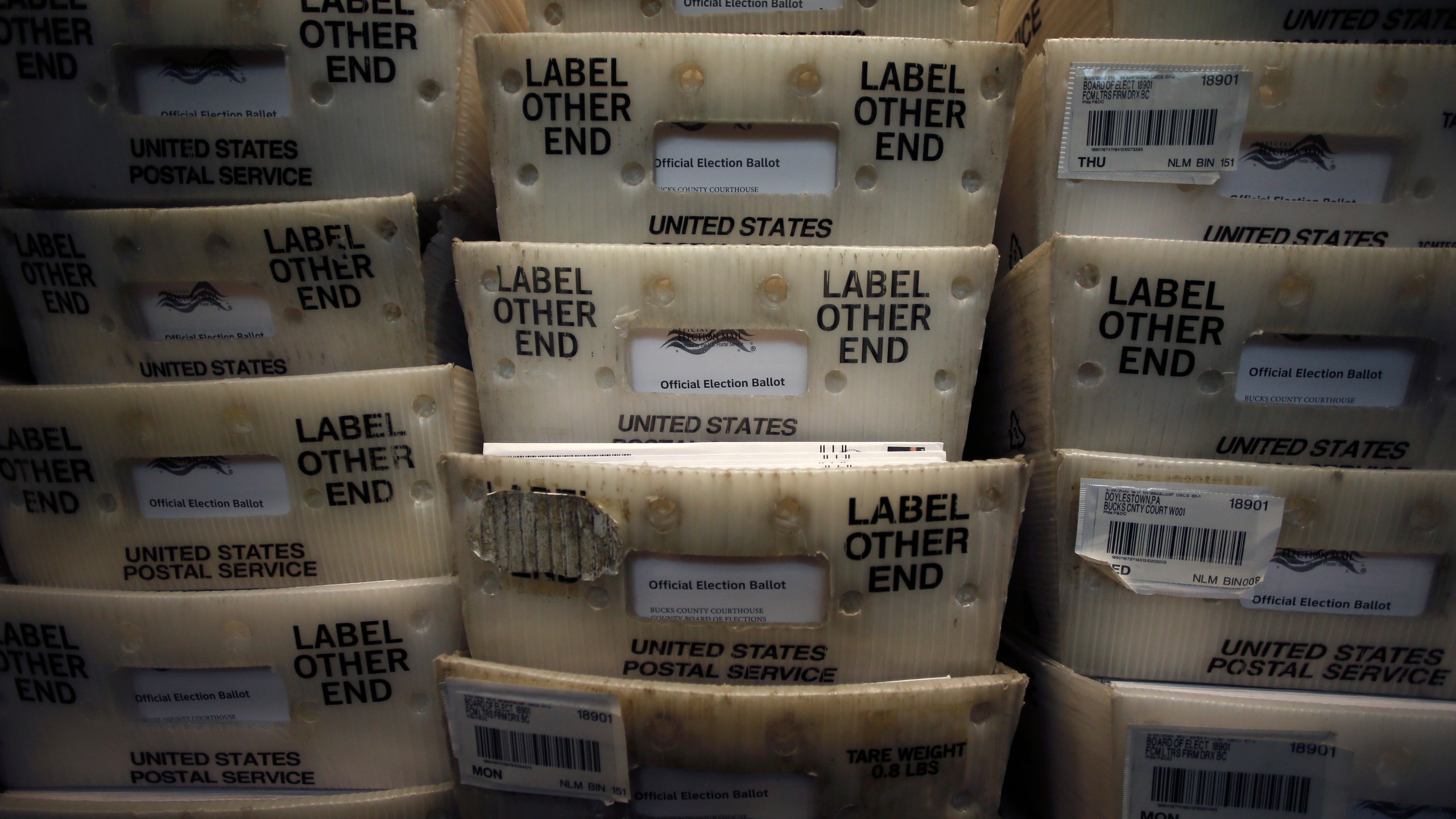 FILE - Processed mail-in ballots are seen at the Bucks County Board of Elections office prior to the primary election in Doylestown, Pa., May 27, 2020. (AP Photo/Matt Slocum, File)