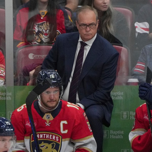 Florida Panthers head coach Paul Maurice keeps an eye on his team during the third period of an NHL hockey game against the Boston Bruins, Tuesday, Oct. 8, 2024, in Sunrise, Fla. (AP Photo/Jim Rassol)