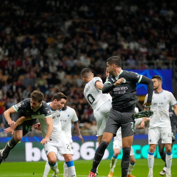 AC Milan's Christian Pulisic, not seen, scores direct from the corner his side's first goal during the Champions League opening phase soccer match between AC Milan and Club Brugge at the San Siro stadium in Milan, Italy, Tuesday, Oct. 22, 2024. (AP Photo/Antonio Calani)