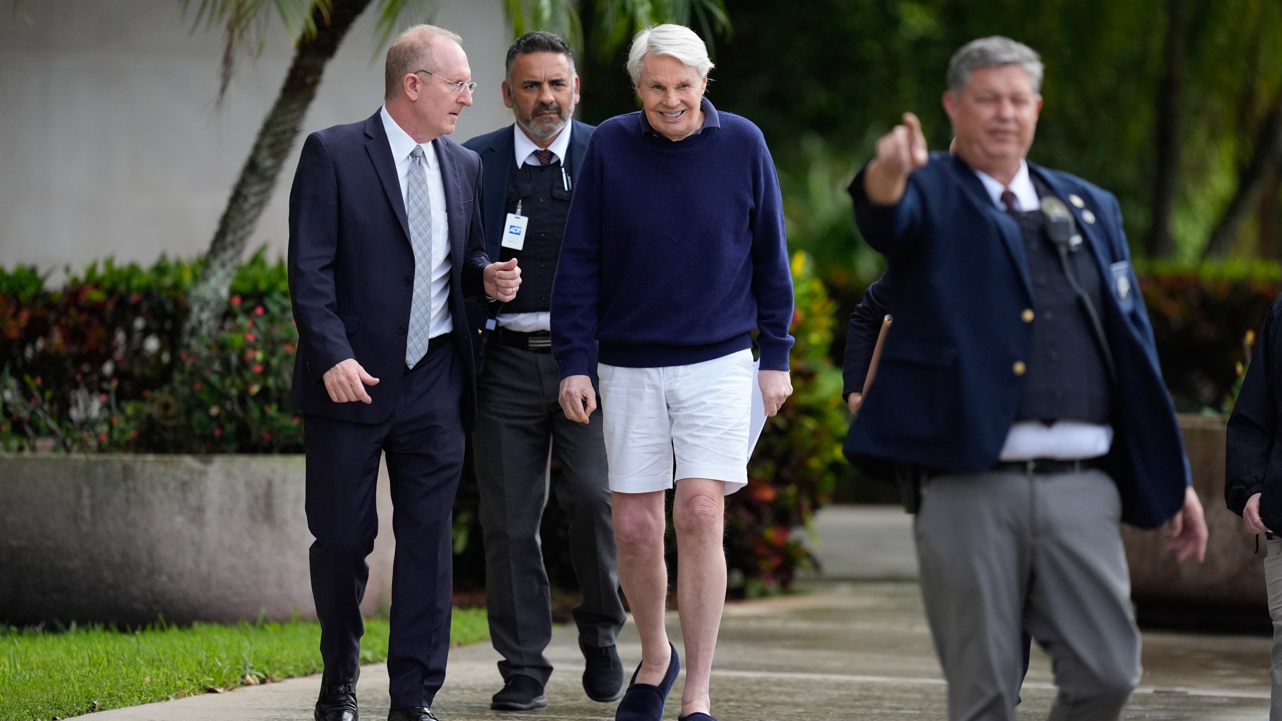 Michael Jeffries, center, former CEO of Abercrombie & Fitch, leaves with his attorney Brian Bieber, left, following a hearing at the Paul G. Rogers Federal Building and U.S. Courthouse in West Palm Beach, Fla., Tuesday, Oct. 22, 2024. (AP Photo/Rebecca Blackwell)