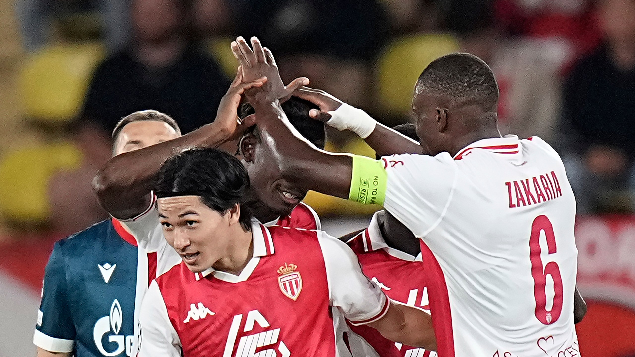 Monaco's Takumi Minamino, center, celebrates with his teammates after scoring the fourth goal during the Champions League opening phase soccer match between Monaco and Crvena Zvezda, Red Star Belgrade, at the Louis II stadium, in Monaco, Tuesday, Oct. 22, 2024. (AP Photo/Laurent Cipriani)