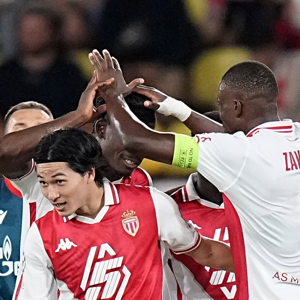 Monaco's Takumi Minamino, center, celebrates with his teammates after scoring the fourth goal during the Champions League opening phase soccer match between Monaco and Crvena Zvezda, Red Star Belgrade, at the Louis II stadium, in Monaco, Tuesday, Oct. 22, 2024. (AP Photo/Laurent Cipriani)