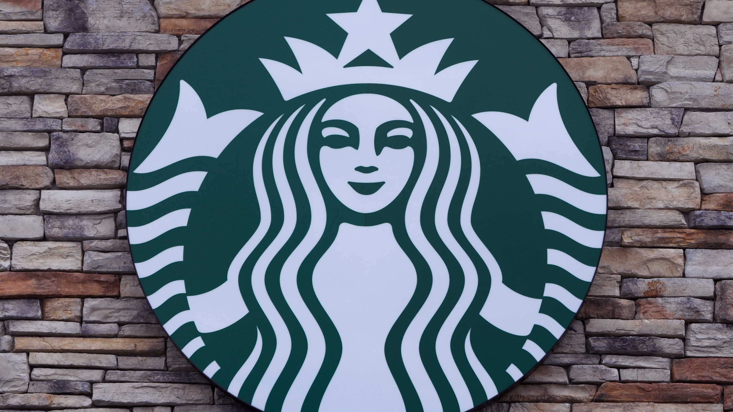 FILE - A Starbucks mermaid logo sign is displayed on a store, May 29, 2024, in Salem, N.H. (AP Photo/Charles Krupa, File)