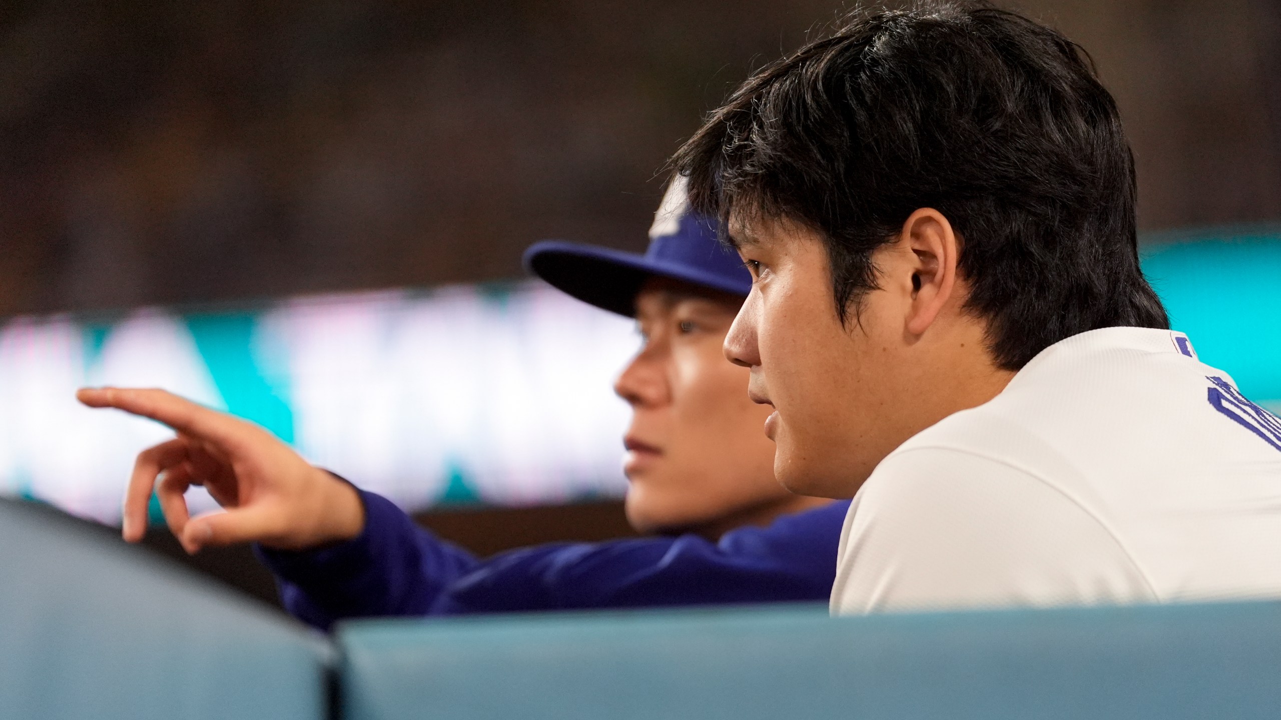 Los Angeles Dodgers' Shohei Ohtani and pitcher Yoshinobu Yamamoto watch during the sixth inning in Game 6 of a baseball NL Championship Series against the New York Mets, Sunday, Oct. 20, 2024, in Los Angeles. (AP Photo/Ashley Landis)