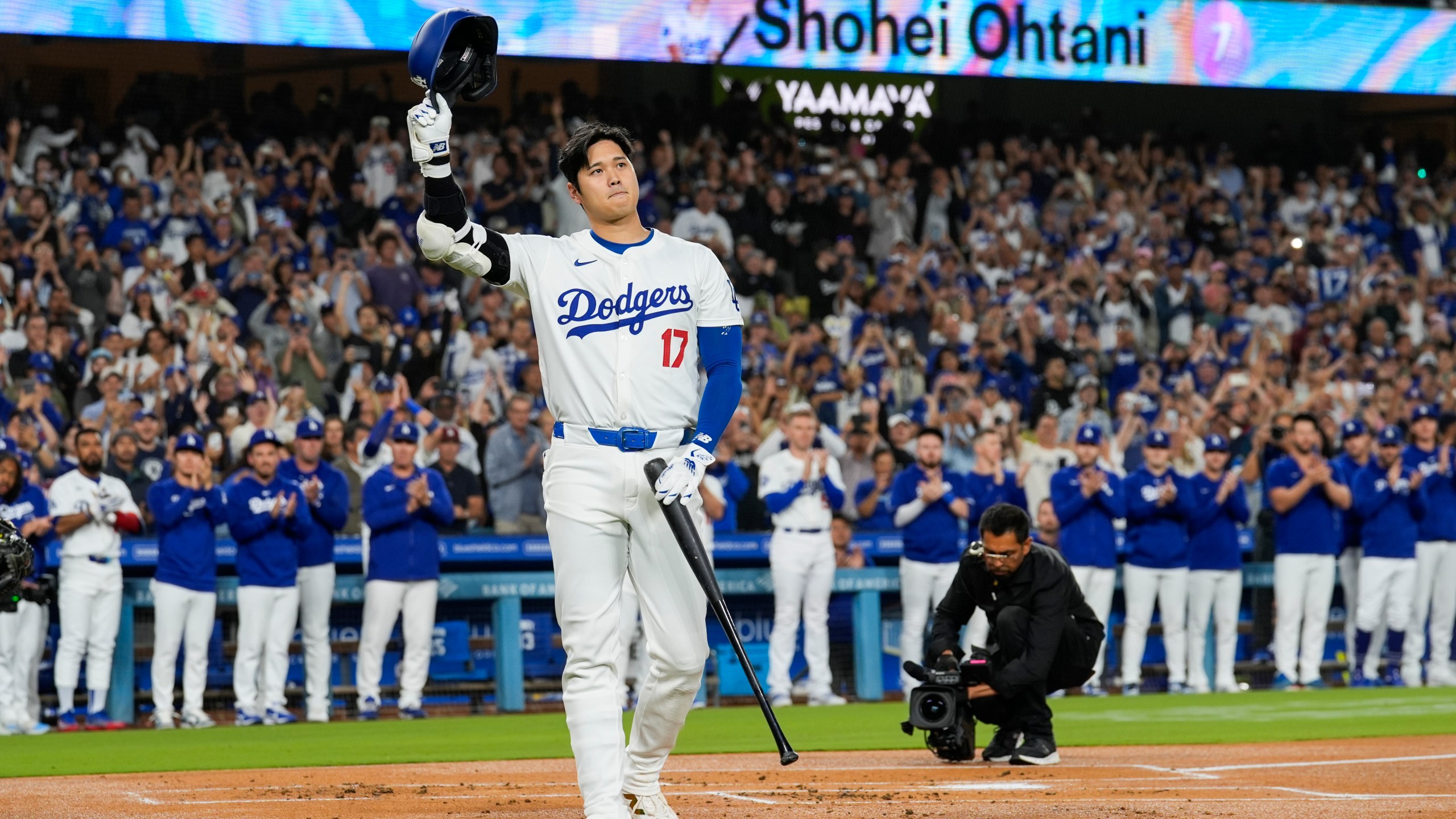 Los Angeles Dodgers designated hitter Shohei Ohtani (17) is honored during the first inning of a baseball game against the Colorado Rockies in Los Angeles, Friday, Sept. 20, 2024. Ohtani was the first MLB player to achieve 50 home runs and 50 stolen bases in a single season. (AP Photo/Ashley Landis)