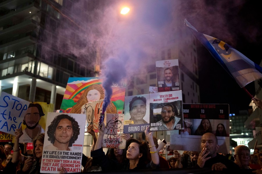 Relatives of Israelis held hostage by Hamas in the Gaza Strip and their supporters protest outside the hotel where U.S. Secretary of State Antony Blinken is staying during a visit with Israeli leadership in Tel Aviv, Tuesday, Oct. 22, 2024. (AP Photo/Maya Alleruzzo)