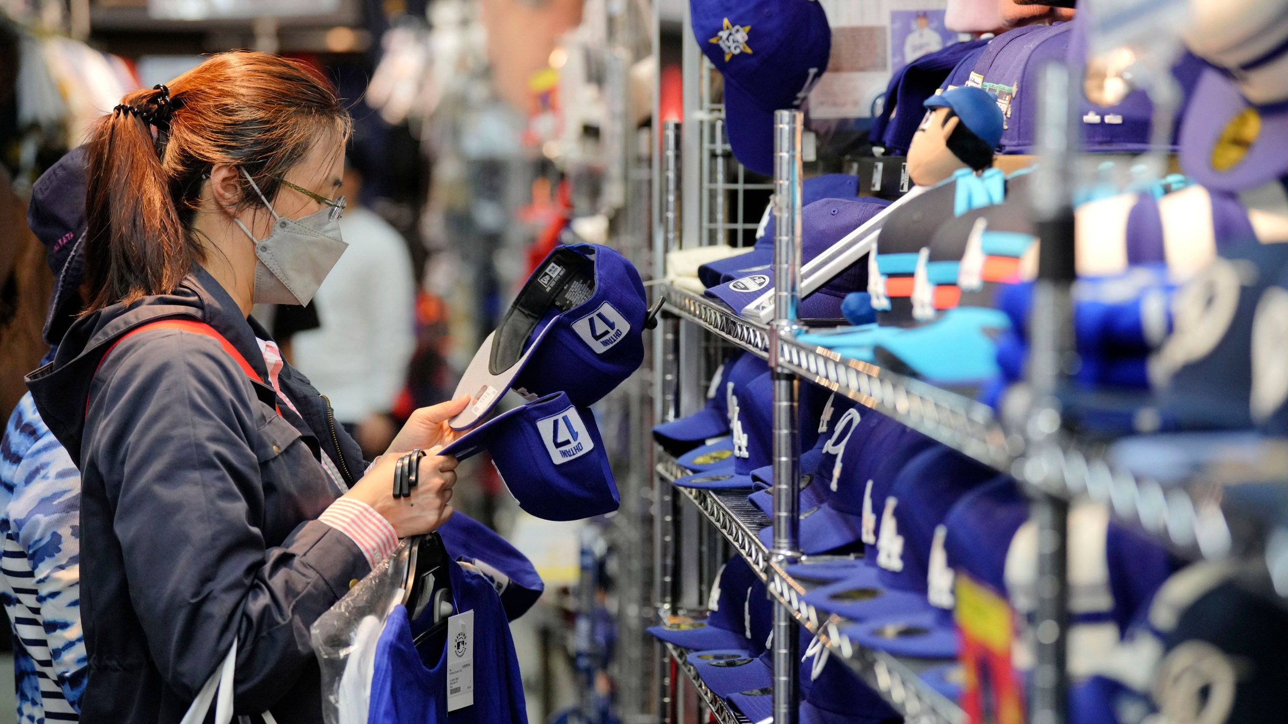 A customer shops around for goods related to Shohei Ohtani of the Los Angeles Dodgers at a sporting goods store, "SELECTION," in Shinjuku district Wednesday, Oct. 23, 2024 in Tokyo. (AP Photo/Eugene Hoshiko)