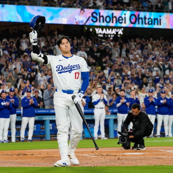 Los Angeles Dodgers designated hitter Shohei Ohtani (17) is honored during the first inning of a baseball game against the Colorado Rockies in Los Angeles, Friday, Sept. 20, 2024. Ohtani was the first MLB player to achieve 50 home runs and 50 stolen bases in a single season. (AP Photo/Ashley Landis)