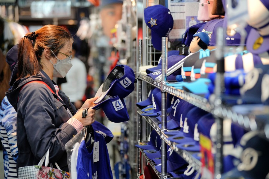 A customer shops around for goods related to Shohei Ohtani of the Los Angeles Dodgers at a sporting goods store, "SELECTION," in Shinjuku district Wednesday, Oct. 23, 2024 in Tokyo. (AP Photo/Eugene Hoshiko)