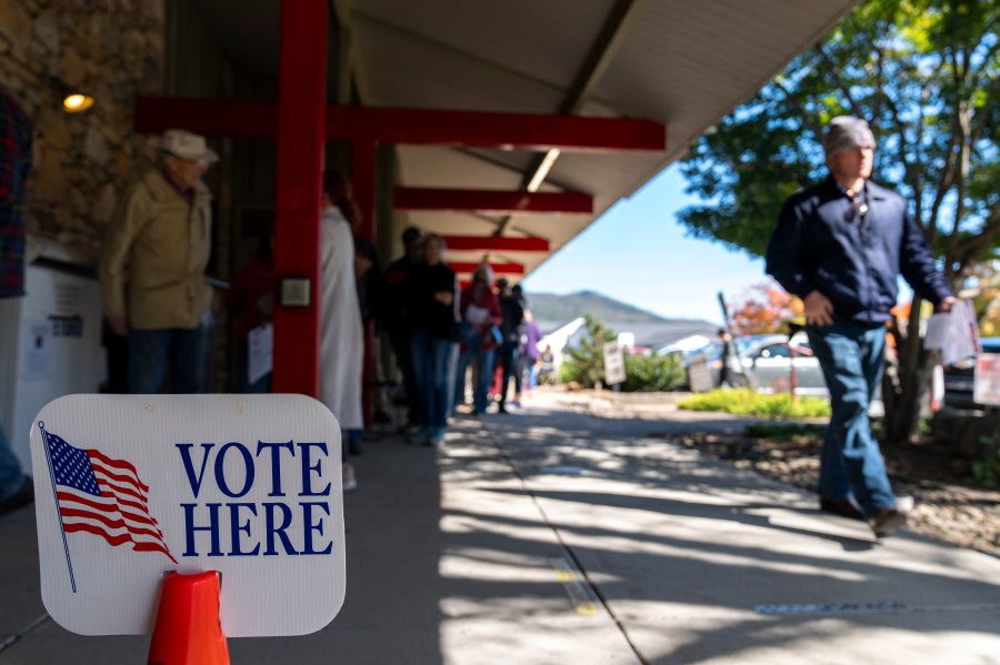 People wait in line at the polling place at Black Mountain Library during the first day of early in-person voting, on Oct. 17, 2024, in Black Mountain, N.C. (AP Photo/Stephanie Scarbrough)