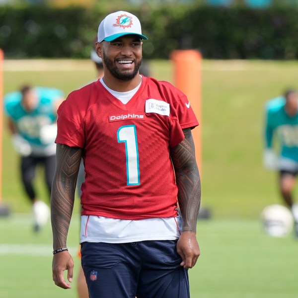 Miami Dolphins quarterback Tua Tagovailoa (1) smiles during a practice session at the team's training facility, Wednesday, Oct. 23, 2024, in Miami Gardens, Fla. (AP Photo/Marta Lavandier)