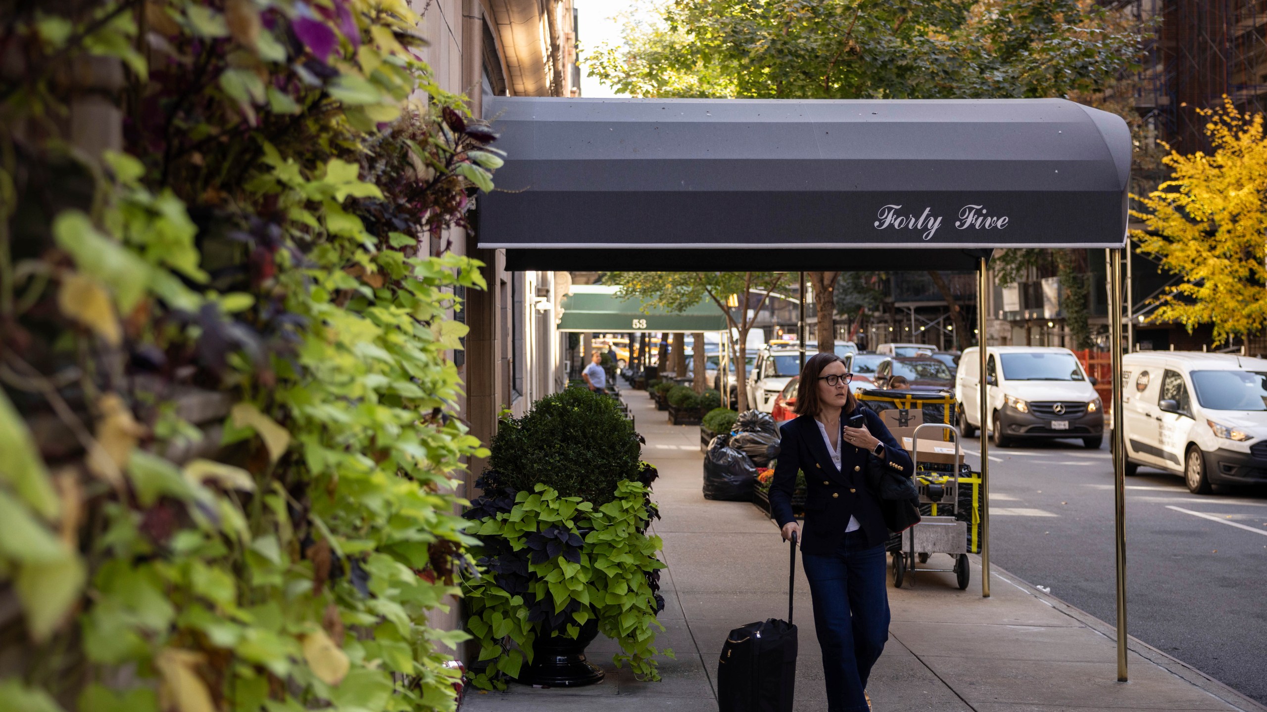 A person walks past the 45 East 66th Street, a building that includes an apartment owned by former New York City Mayor Rudy Giuliani, Wednesday, Oct. 23, 2024, in New York. (AP Photo/Yuki Iwamura)