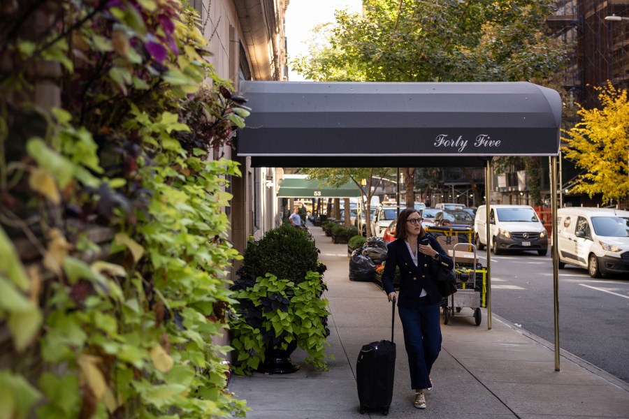 A person walks past the 45 East 66th Street, a building that includes an apartment owned by former New York City Mayor Rudy Giuliani, Wednesday, Oct. 23, 2024, in New York. (AP Photo/Yuki Iwamura)