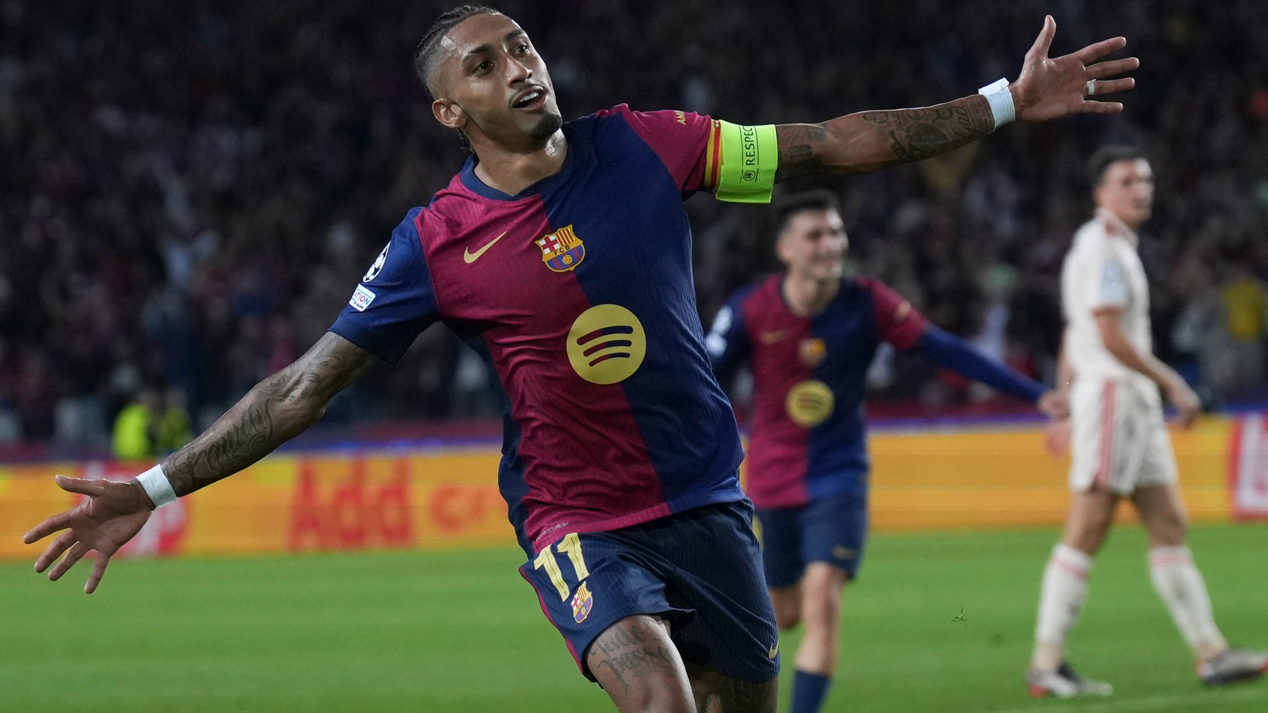 Barcelona's Raphinha celebrates after scoring his side's third goal during the Champions League opening phase soccer match between Barcelona and Bayern Munich at the Lluis Companys Olympic Stadium in Barcelona, Spain, Wednesday, Oct. 23, 2024. (AP Photo/Emilio Morenatti)