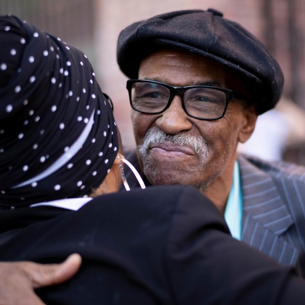 Herbert Rice, 79, right, is embraced by Adrianne Jones-Alston, on Wednesday, Oct. 23, 2024, in Philadelphia. (AP Photo/Laurence Kesterson)