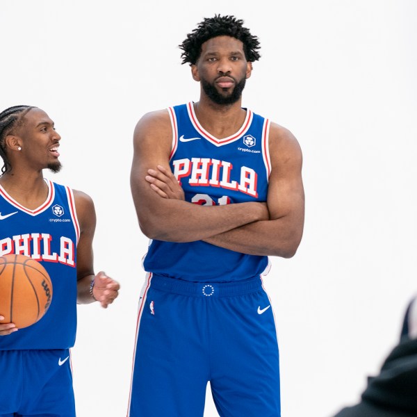 Philadelphia 76ers' Tyrese Maxey, left, reacts as he poses with Joel Embiid, right, for photos during the NBA basketball team's media day, Monday, Sept. 30, 2024, in Camden, N.J.. (AP Photo/Chris Szagola)