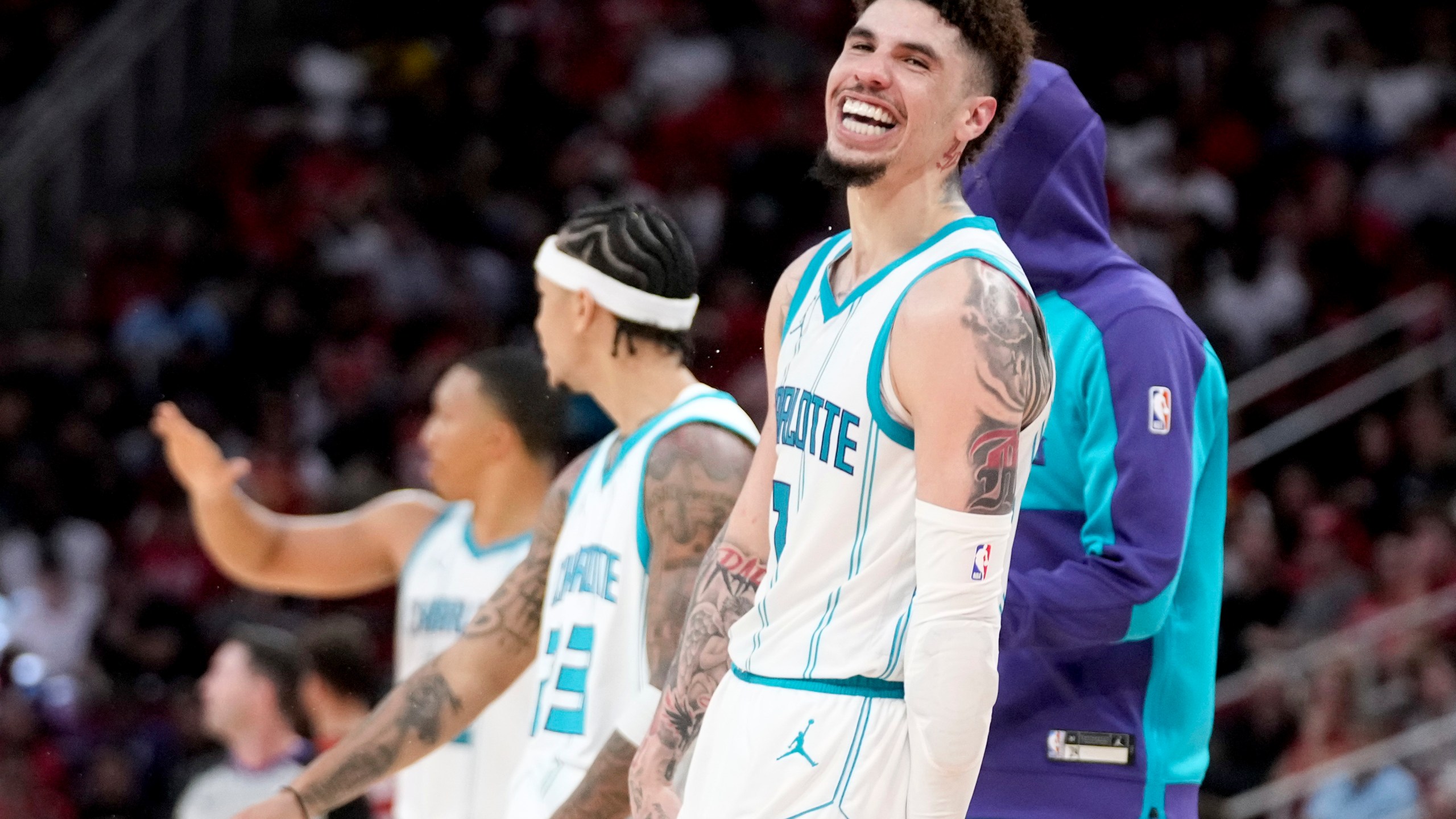 Charlotte Hornets guard LaMelo Ball, right, reacts after making a three point basket against the Houston Rockets during the second half of an NBA basketball game Wednesday, Oct. 23, 2024, in Houston. (AP Photo/Eric Christian Smith)