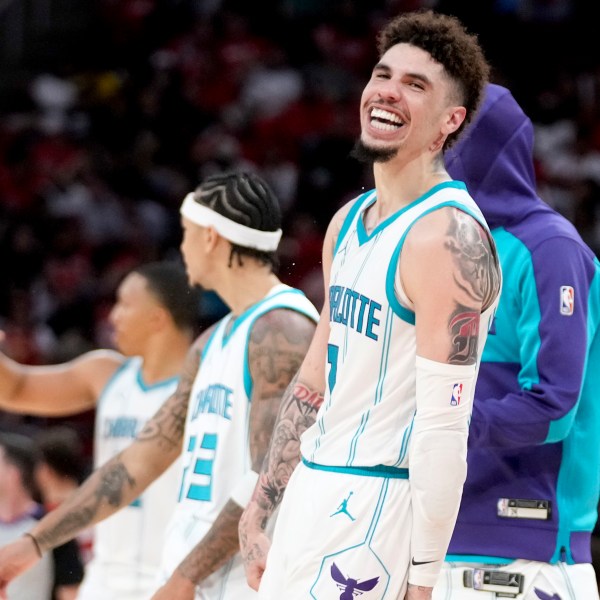 Charlotte Hornets guard LaMelo Ball, right, reacts after making a three point basket against the Houston Rockets during the second half of an NBA basketball game Wednesday, Oct. 23, 2024, in Houston. (AP Photo/Eric Christian Smith)