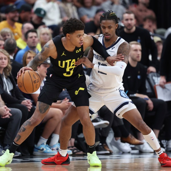 Utah Jazz guard Keyonte George (3) dribbles the ball while Memphis Grizzlies guard Ja Morant (12) defends during the first half of an NBA basketball game, Wednesday, Oct. 23, 2024, in Salt Lake City. (AP Photo/Rob Gray)