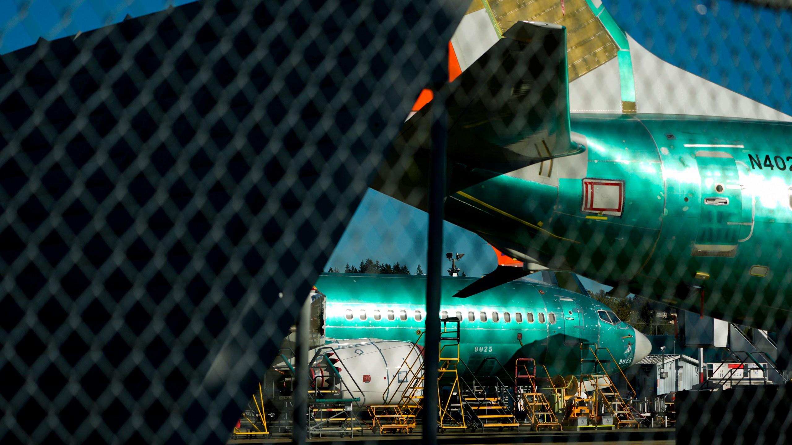 Boeing 737 Max aircrafts are seen behind fences, Tuesday, Sept. 24, 2024, at the company's facilities in Renton, Wash. (AP Photo/Lindsey Wasson)