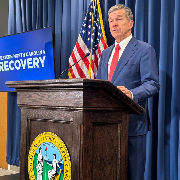 North Carolina Gov. Roy Cooper unveils a report about damages caused by Hurricane Helene and his $3.9 billion request to the General Assembly for recovery initiatives during a press conference at the Albemarle Building in Raleigh, N.C., Wednesday, Oct. 23, 2024. (AP Photo/Gary D. Robertson)