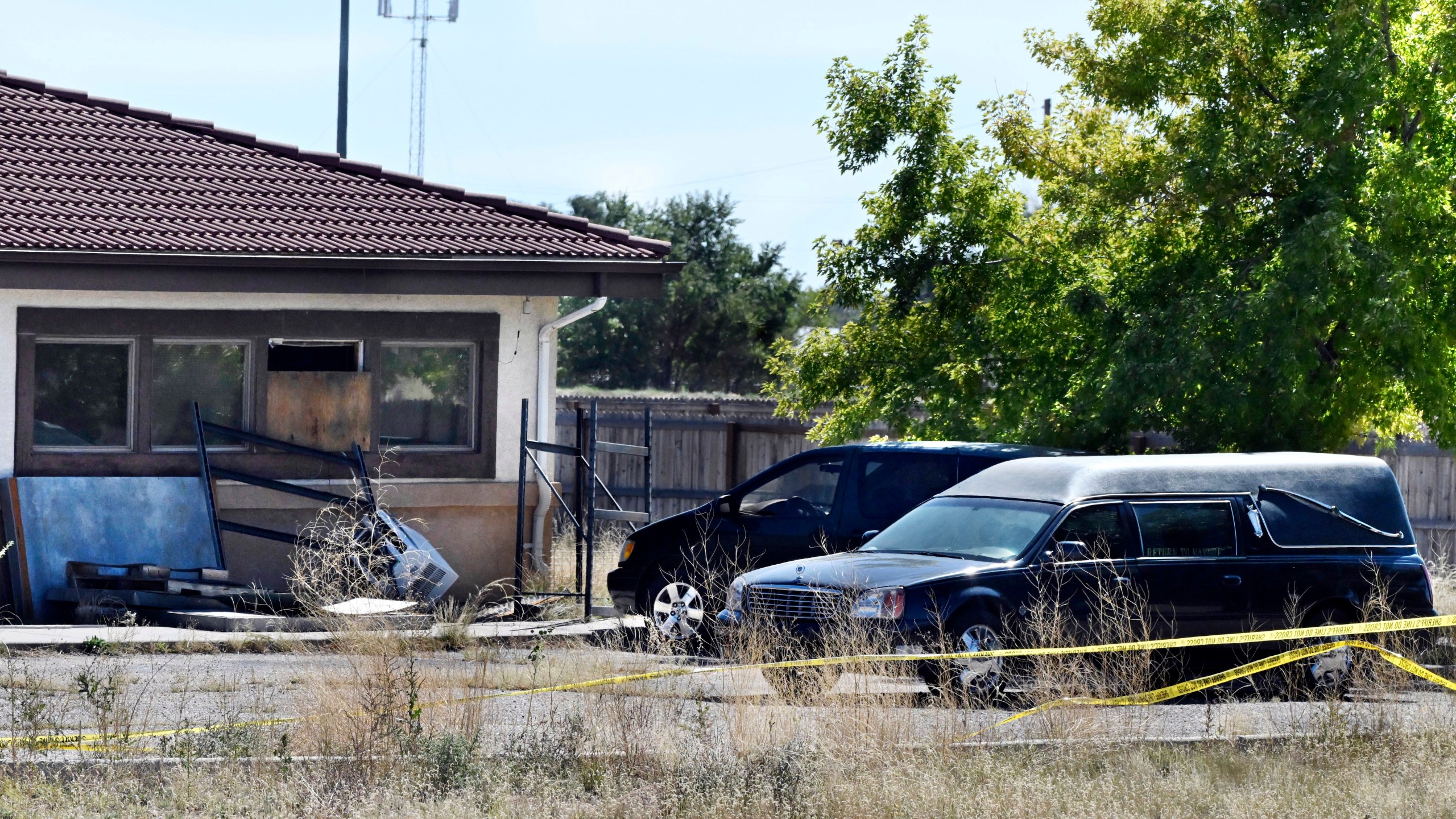 FILE - A hearse and debris can be seen at the rear of the Return to Nature Funeral Home, Oct. 5, 2023, in Penrose, Colo. (Jerilee Bennett/The Gazette via AP, File)