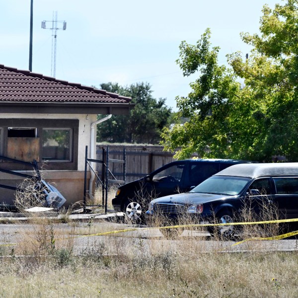 FILE - A hearse and debris can be seen at the rear of the Return to Nature Funeral Home, Oct. 5, 2023, in Penrose, Colo. (Jerilee Bennett/The Gazette via AP, File)