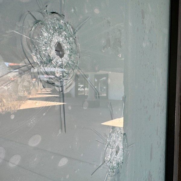 Bullet holes remain in the glass window at a Democratic Party campaign office in Tempe, Ariz., Wednesday, Sept. 25, 2024. (AP Photo/Gabriel Sandoval)