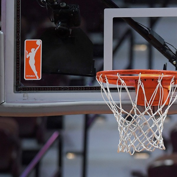 FILE - The WNBA logo and hoop are seen at a WNBA basketball game at Mohegan Sun Arena, Tuesday, May 14, 2019, in Uncasville, Conn. (AP Photo/Jessica Hill, File)