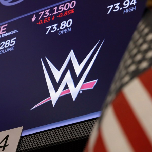 The logo for World Wrestling Entertainment, WWE, appears above a trading post on the floor of the New York Stock Exchange, Sept. 13, 2019. (AP Photo/Richard Drew)