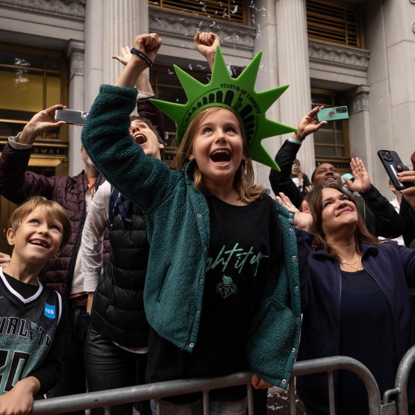 Spectators react as a float with members of the New York Liberty make its way up Broadway during the WNBA basketball championship parade Thursday, Oct. 24, 2024, in New York. (AP Photo/Yuki Iwamura)