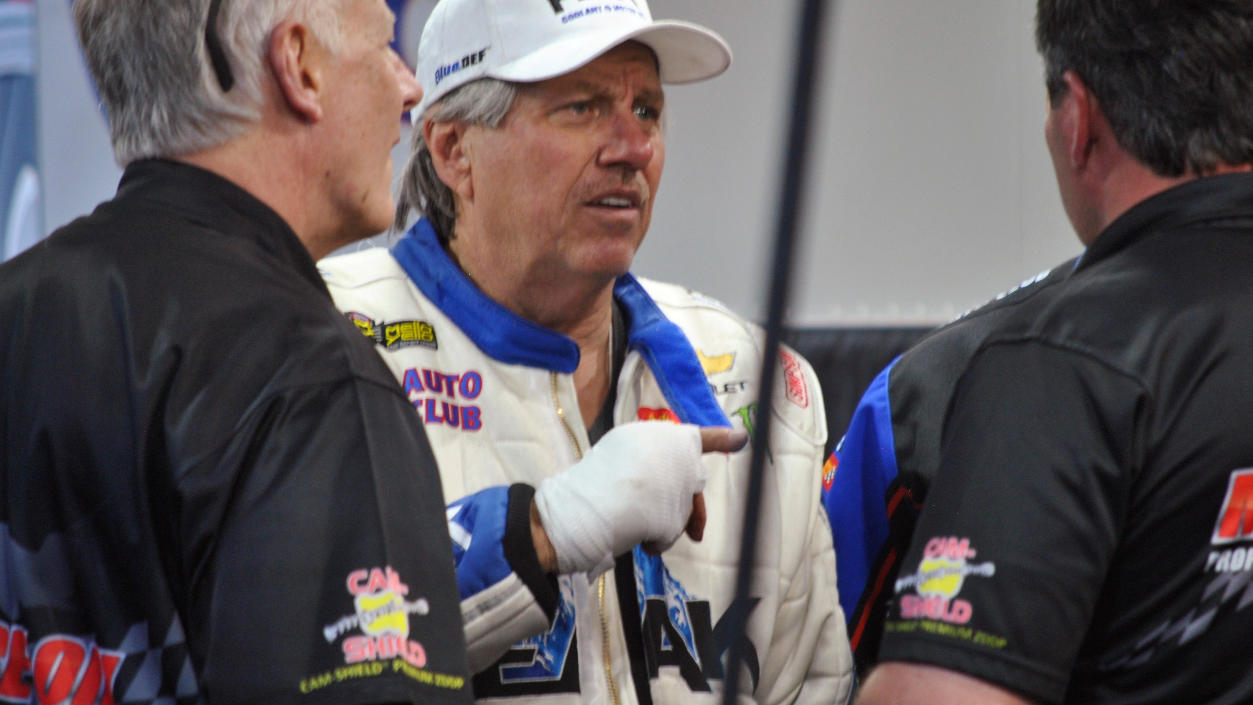 FILE - John Force talks to crew members after his Funny Car blew an engine and destroyed the body of his dragster, Friday, March 16, 2018, at the NHRA Gatornationals in Gainesville, Fla. (AP Photo/Mark Long, File)