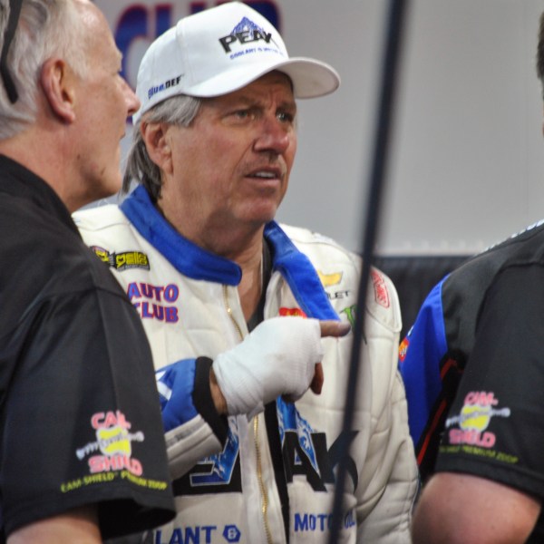 FILE - John Force talks to crew members after his Funny Car blew an engine and destroyed the body of his dragster, Friday, March 16, 2018, at the NHRA Gatornationals in Gainesville, Fla. (AP Photo/Mark Long, File)