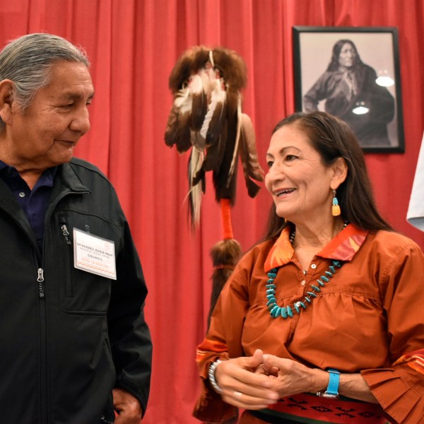 FILE - Russell Eagle Bear, with the Rosebud Sioux Reservation Tribal Council, talks to U.S. Interior Secretary Deb Haaland during a meeting about Native American boarding schools at Sinte Gleska University in Mission, S.D., on Oct. 15, 2022. (AP Photo/Matthew Brown, File)