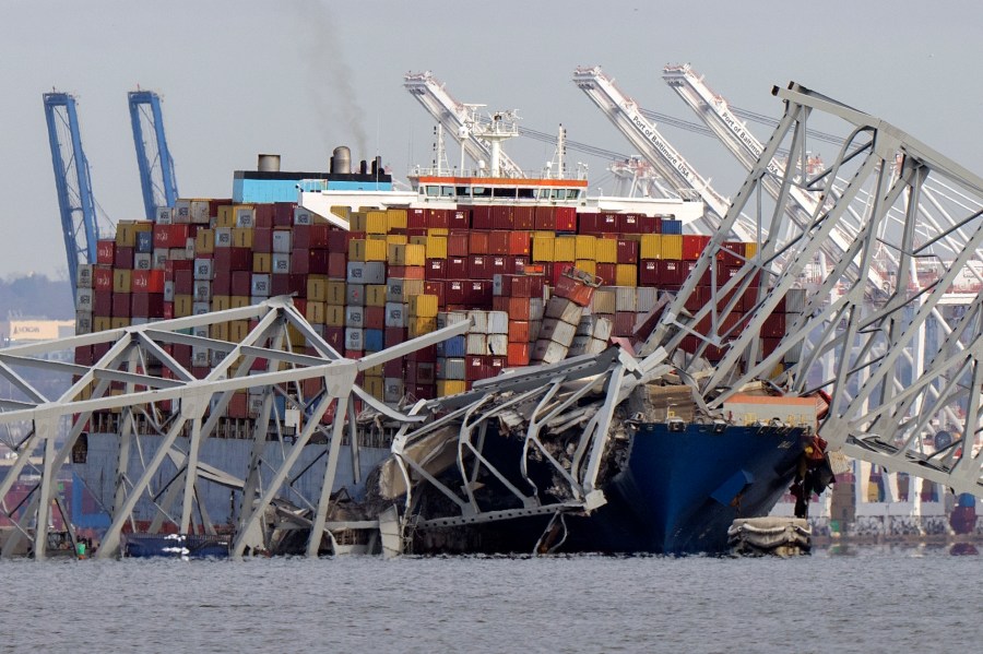 FILE - The cargo ship Dali is stuck under part of the structure of the Francis Scott Key Bridge after the ship hit the bridge, Tuesday, March 26, 2024, as seen from Pasadena, Md. (AP Photo/Mark Schiefelbein, File)