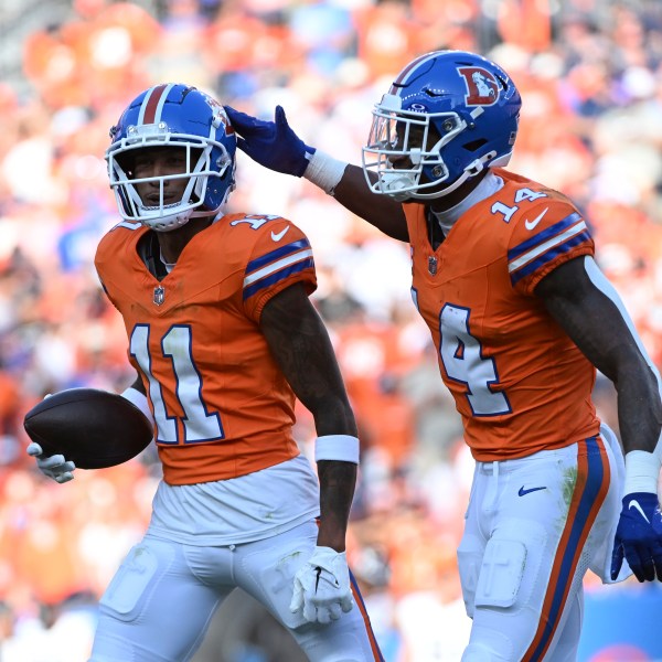 Denver Broncos wide receiver Josh Reynolds (11) celebrates his 9-yard reception for a touchdown with teammate wide receiver Courtland Sutton (14) during the second half of an NFL football game against the Las Vegas Raiders, Sunday, Oct. 6, 2024, in Denver. (AP Photo/Geneva Heffernan)