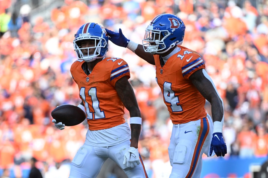 Denver Broncos wide receiver Josh Reynolds (11) celebrates his 9-yard reception for a touchdown with teammate wide receiver Courtland Sutton (14) during the second half of an NFL football game against the Las Vegas Raiders, Sunday, Oct. 6, 2024, in Denver. (AP Photo/Geneva Heffernan)