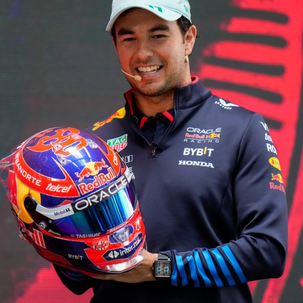 Red Bull driver Sergio Perez, from Mexico, shows his helmet during a press conference in Mexico City, Wednesday, Oct. 23, 2024, ahead of the weekend Formula One Mexico Grand Prix auto race. (AP Photo/Moises Castillo)